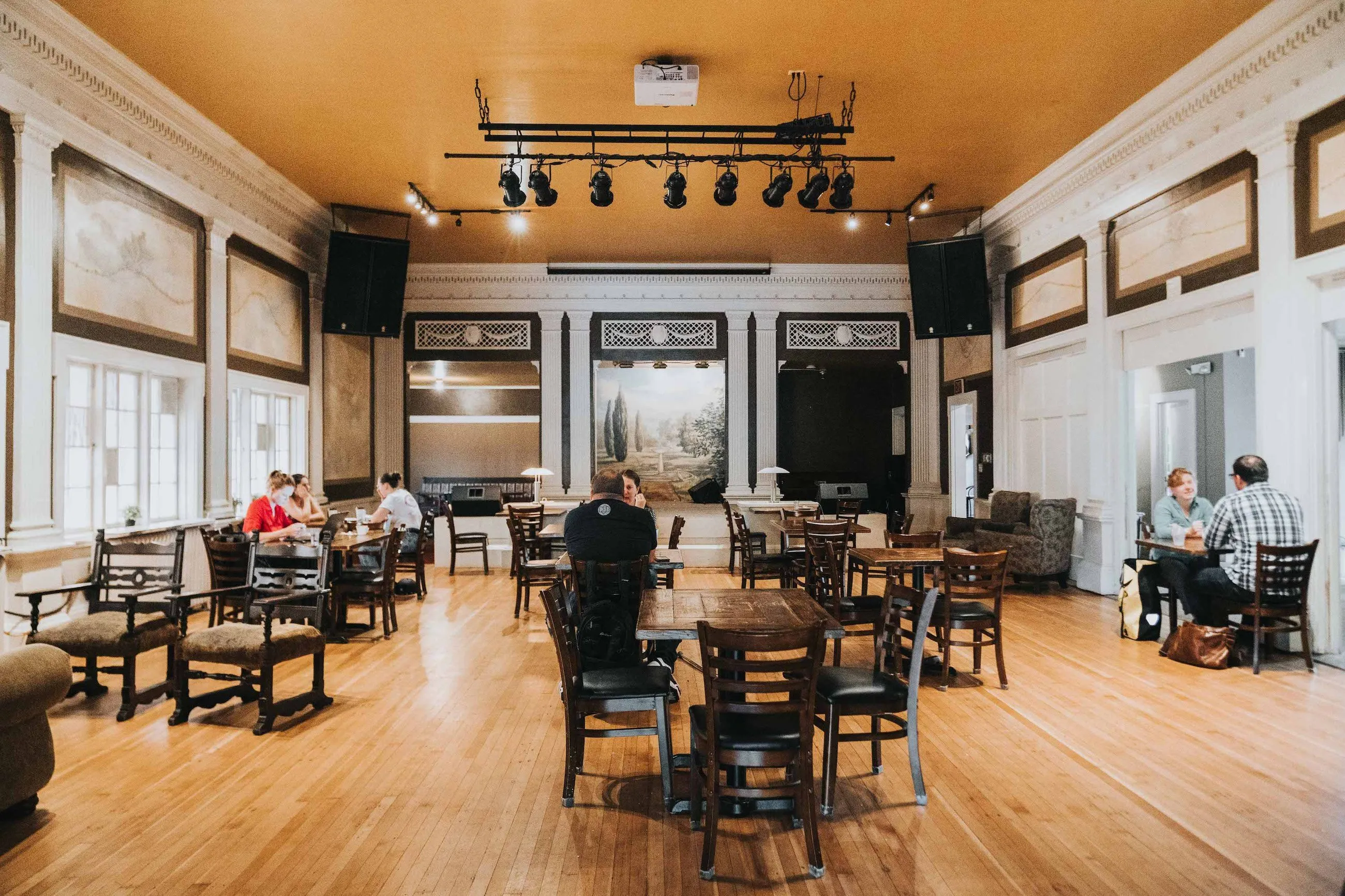 The warm brick interior of IKE Box Coffee during a community gathering