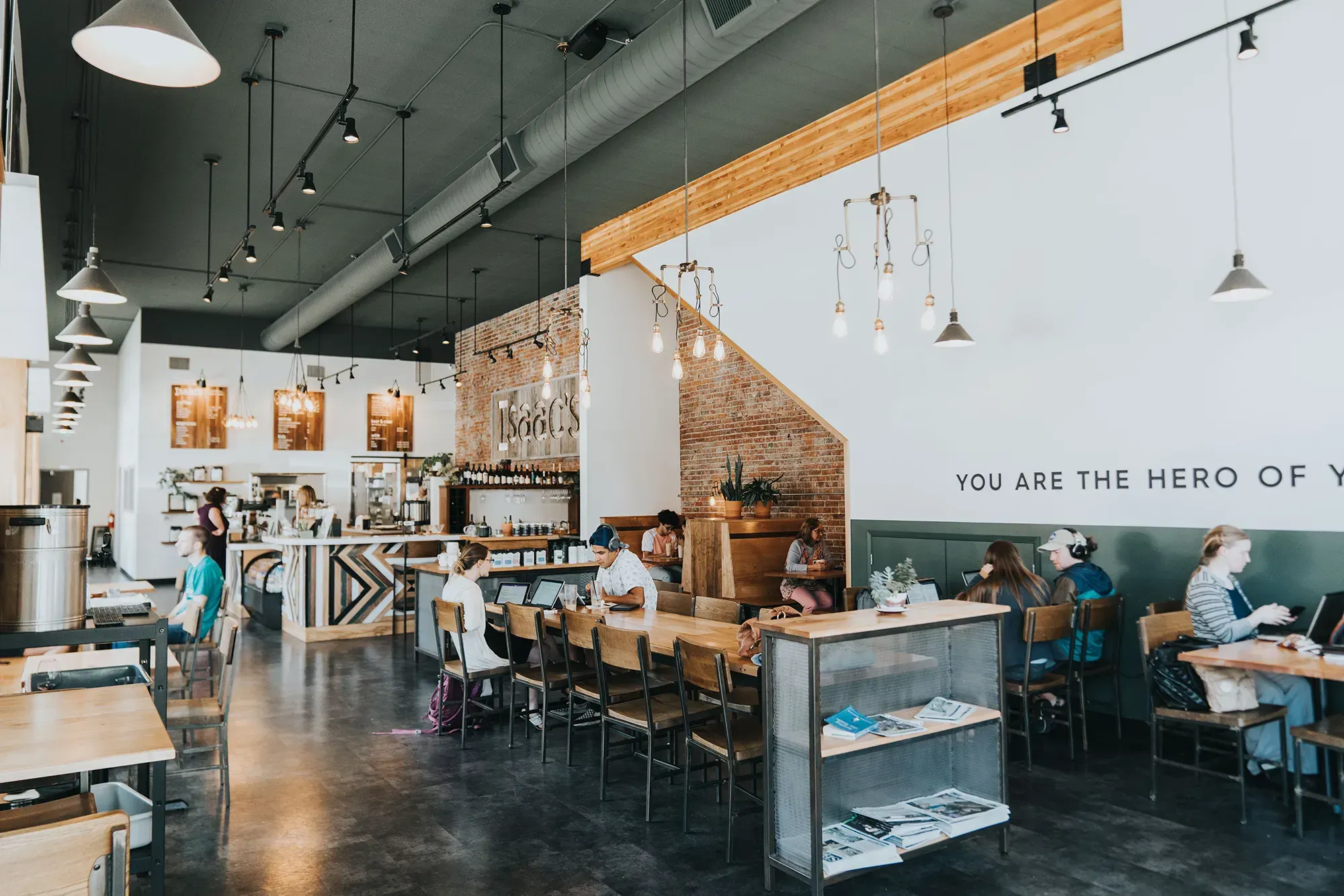 The warm brick interior of IKE Box Coffee during a community gathering