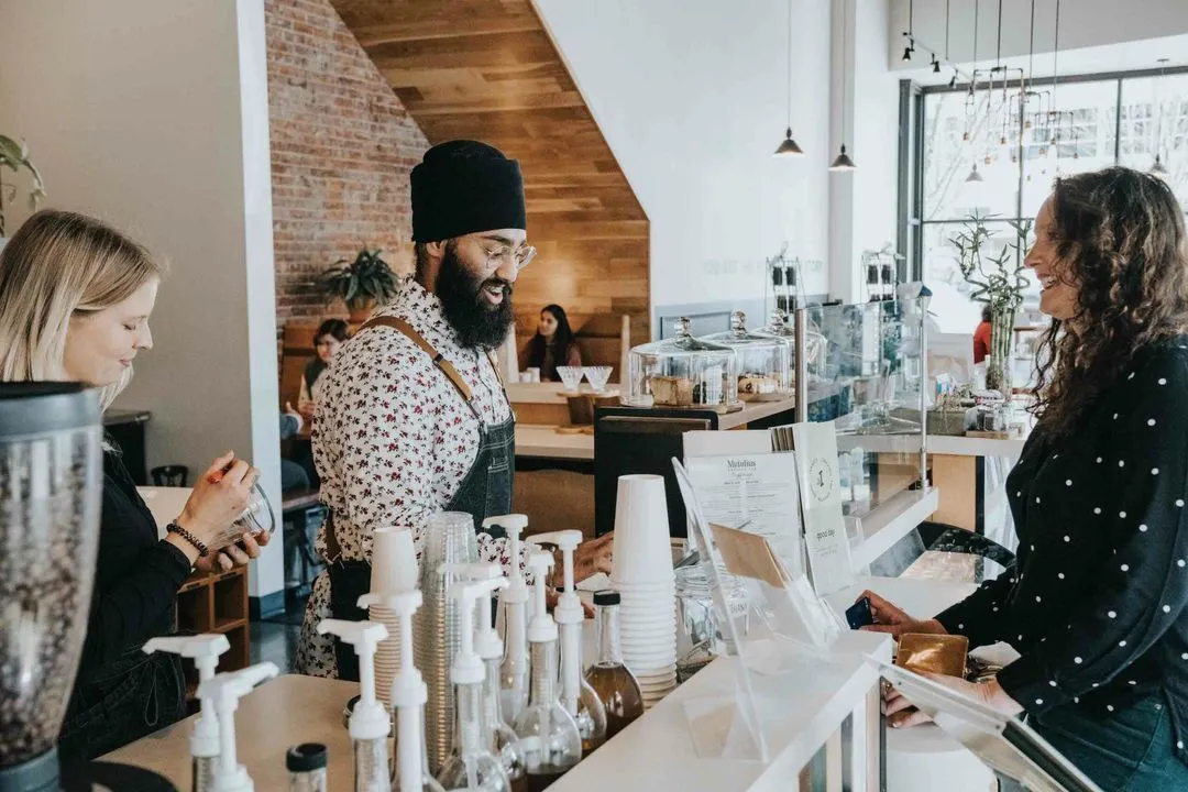 Barista connecting with a customer inside an Isaac's café